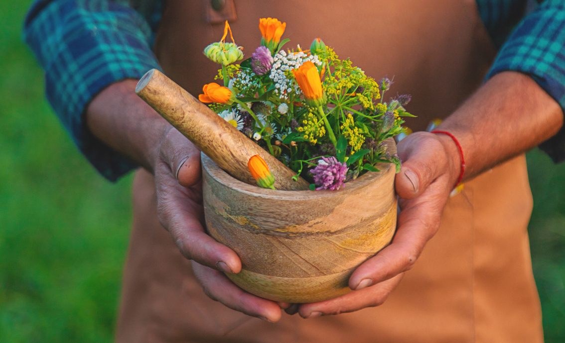 Vista exterior de un herbolario en Sevilla, fachada verde con carteles de productos naturales y ambiente amigable